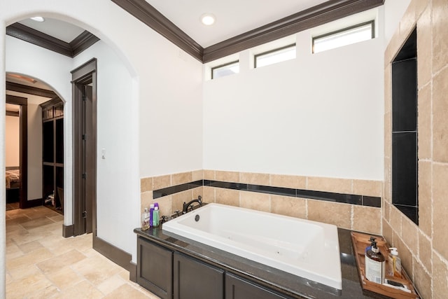 full bath featuring ornamental molding, recessed lighting, stone finish flooring, and a bath