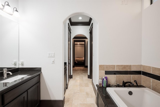 full bath featuring stone finish floor, a bath, and vanity