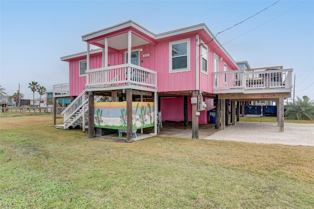 back of property with a carport and a yard