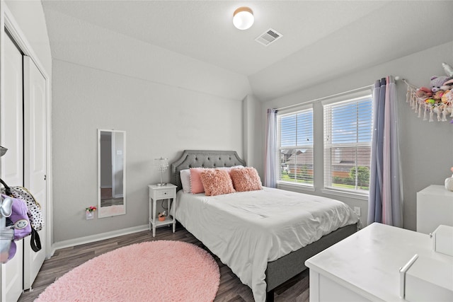 bedroom featuring lofted ceiling and dark hardwood / wood-style flooring