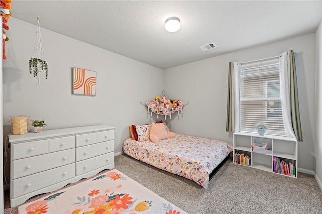 bedroom featuring a textured ceiling and carpet