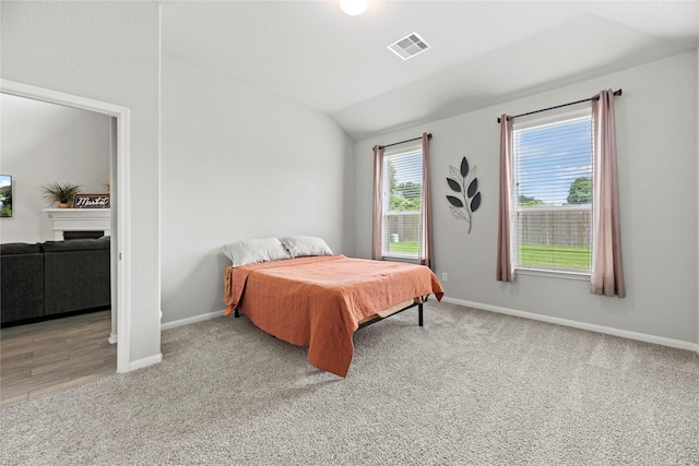 bedroom featuring carpet flooring and vaulted ceiling