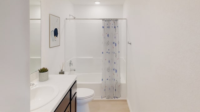 bathroom featuring toilet, shower / bathtub combination with curtain, and vanity