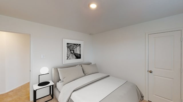 bedroom with light carpet and recessed lighting