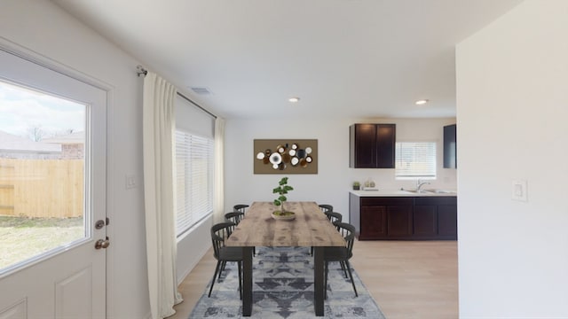 dining room featuring light wood-type flooring, visible vents, and recessed lighting