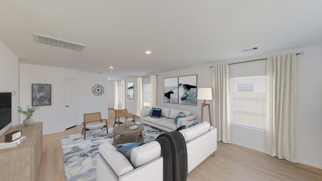 living room featuring light wood-type flooring, visible vents, and recessed lighting