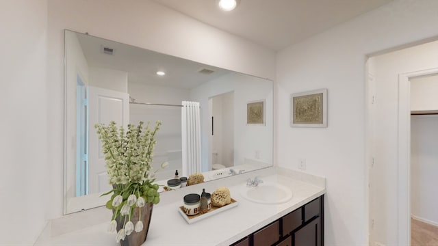 bathroom with recessed lighting, visible vents, vanity, and toilet