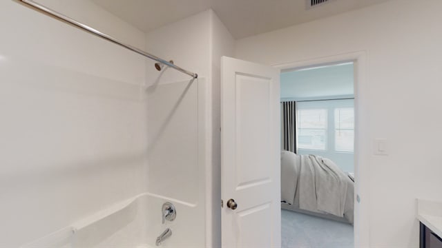 ensuite bathroom with tub / shower combination, connected bathroom, and vanity