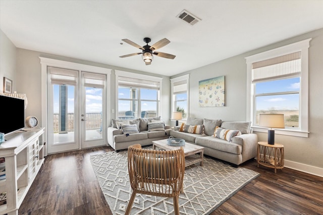 living room with dark wood-type flooring, ceiling fan, and french doors