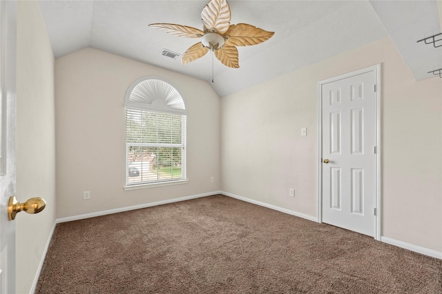 carpeted spare room with vaulted ceiling and ceiling fan