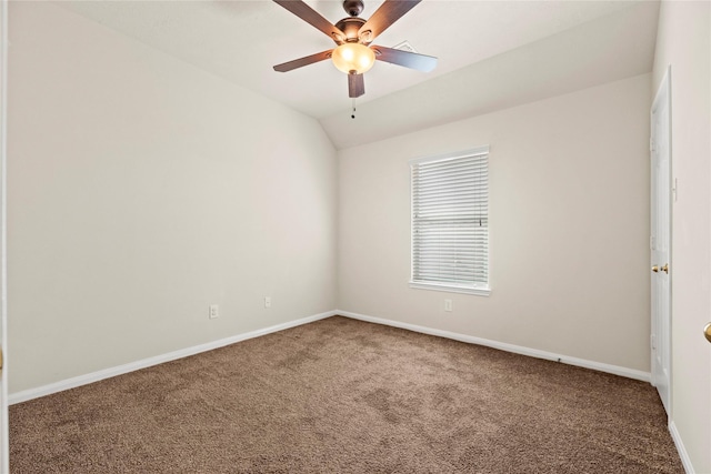 carpeted empty room featuring vaulted ceiling and ceiling fan