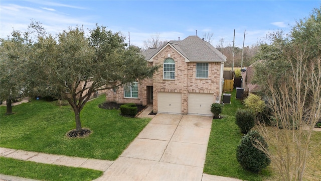 view of property featuring a garage, a front lawn, and central air condition unit