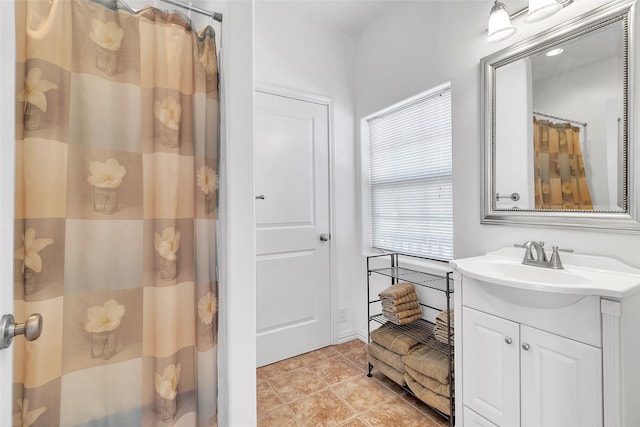 full bath featuring curtained shower, vanity, and tile patterned floors