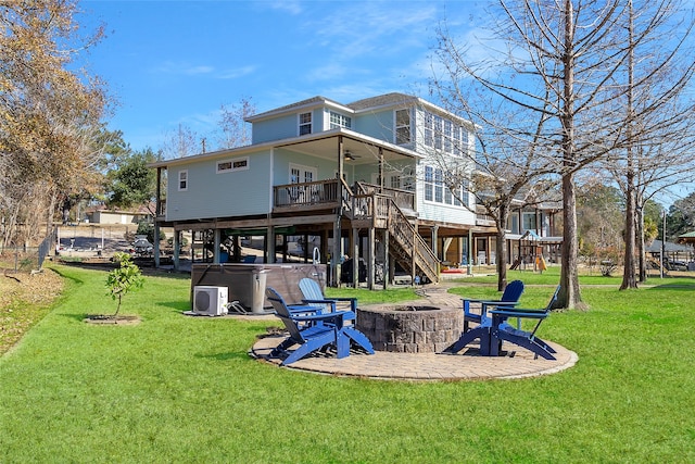 view of jungle gym featuring a patio, a lawn, a ceiling fan, a fire pit, and stairs