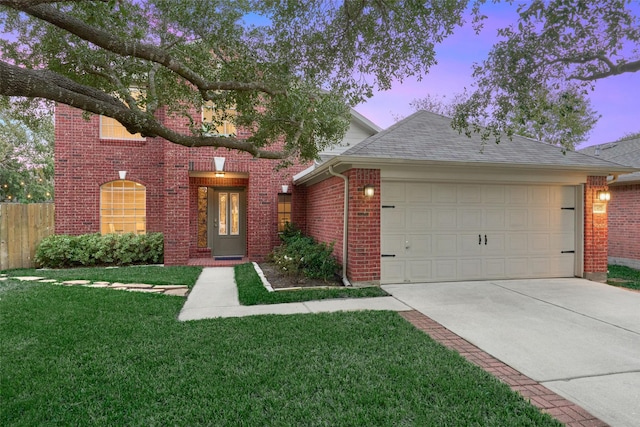 view of front facade with a garage and a lawn