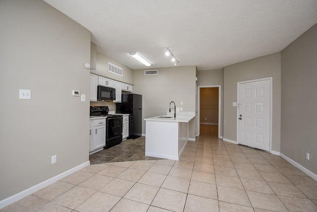 kitchen featuring sink, black appliances, white cabinets, light tile patterned flooring, and kitchen peninsula