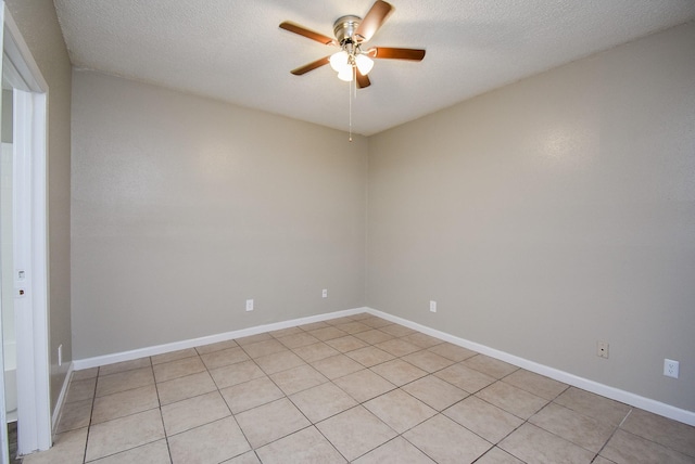 empty room with ceiling fan and a textured ceiling