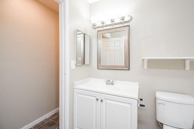 bathroom with vanity, tile patterned floors, and toilet