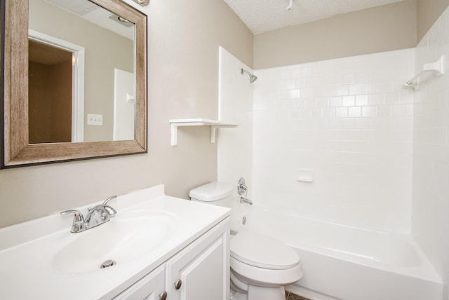 full bathroom featuring vanity, toilet, tiled shower / bath combo, and a textured ceiling