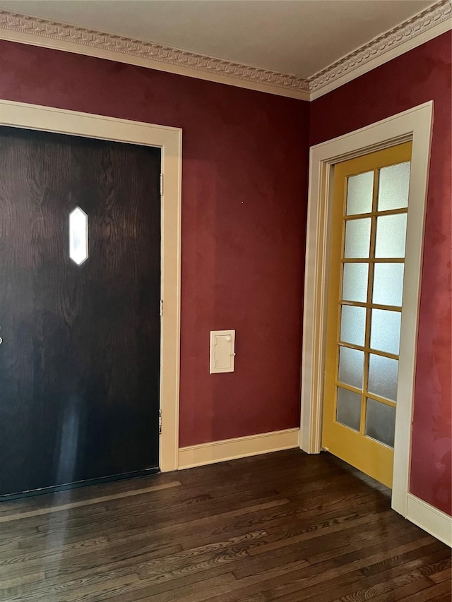 doorway to outside with crown molding, dark wood finished floors, and baseboards