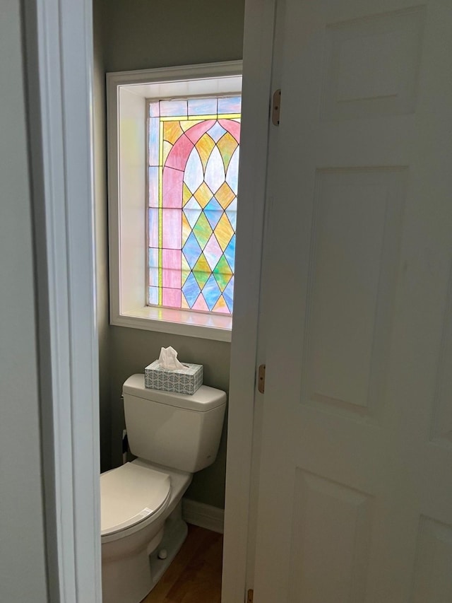 bathroom featuring wood finished floors, toilet, and baseboards