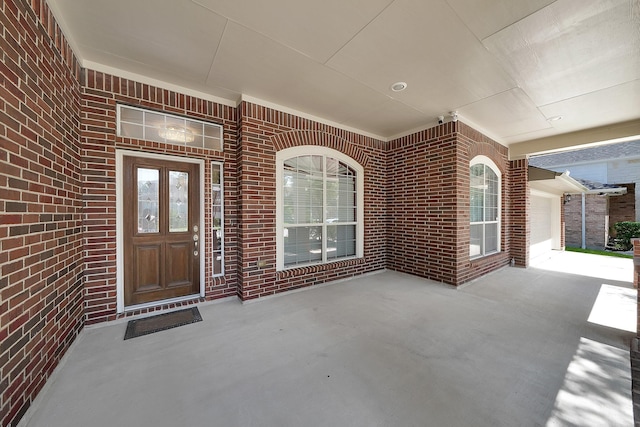 doorway to property with a garage