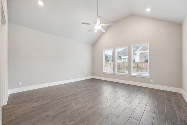 empty room with dark wood-type flooring, high vaulted ceiling, and ceiling fan