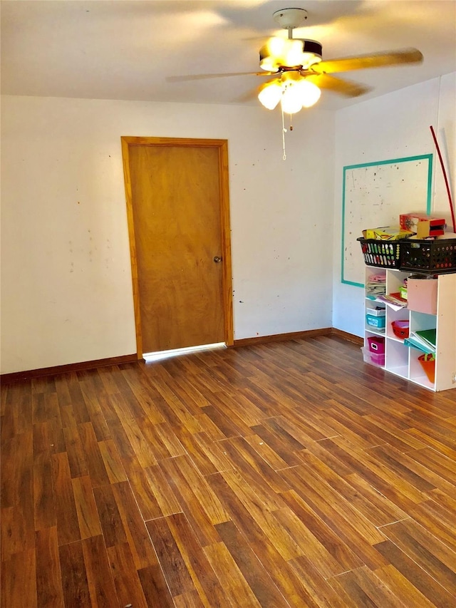 spare room featuring ceiling fan and dark hardwood / wood-style floors