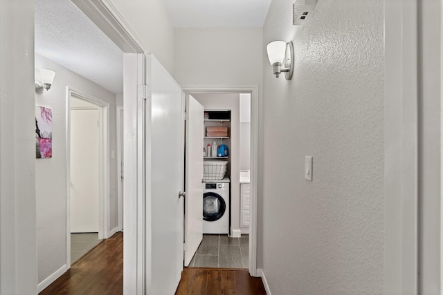 corridor featuring dark wood-type flooring and washer / clothes dryer