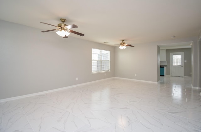 unfurnished room featuring plenty of natural light and ceiling fan