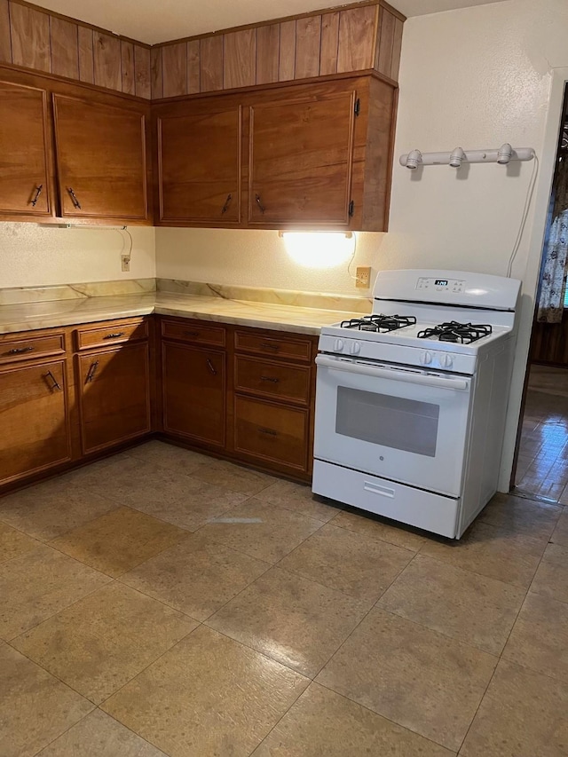 kitchen featuring white range with gas cooktop