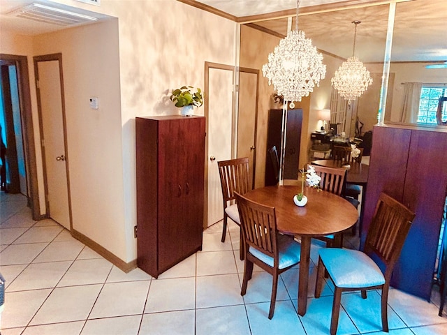 dining room featuring baseboards, light tile patterned flooring, visible vents, and a notable chandelier