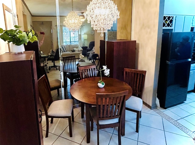 dining space featuring a chandelier, light tile patterned flooring, and crown molding