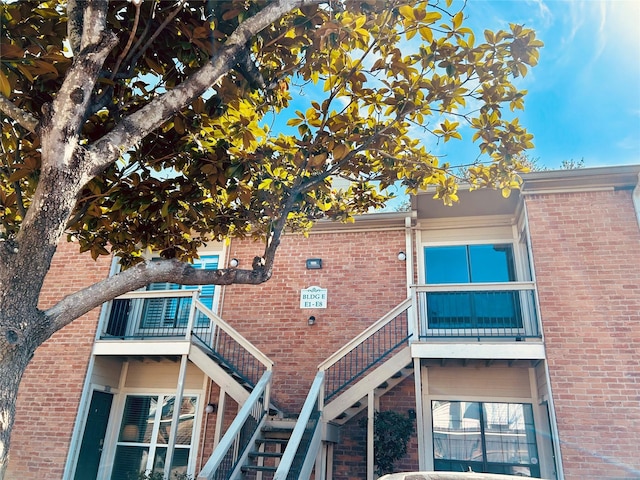 view of building exterior featuring central AC unit and stairway