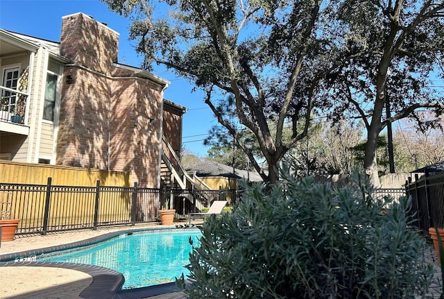 view of swimming pool featuring a fenced backyard and a fenced in pool