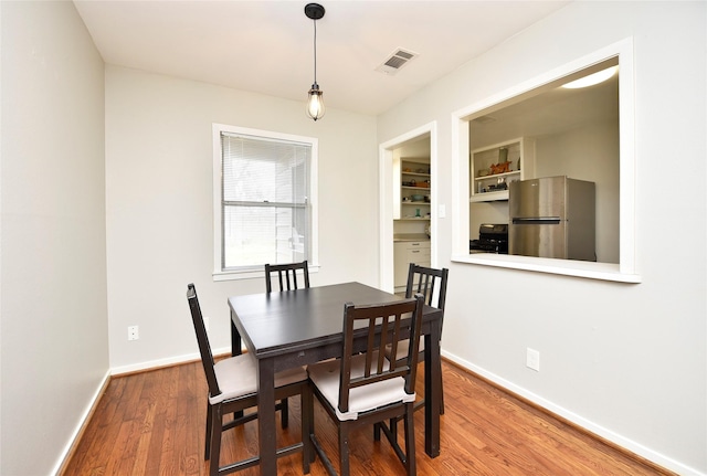 dining space featuring hardwood / wood-style floors