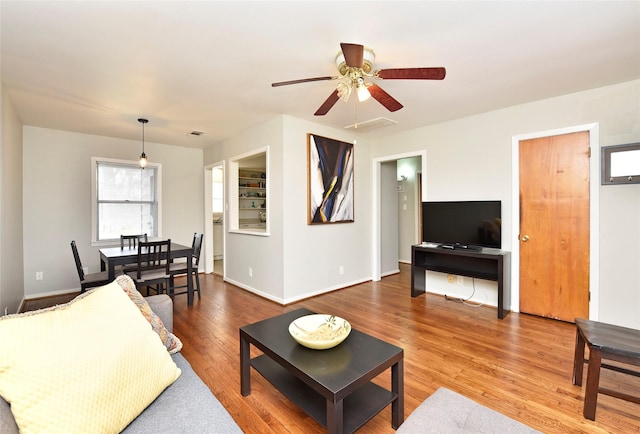 living room featuring hardwood / wood-style flooring and ceiling fan