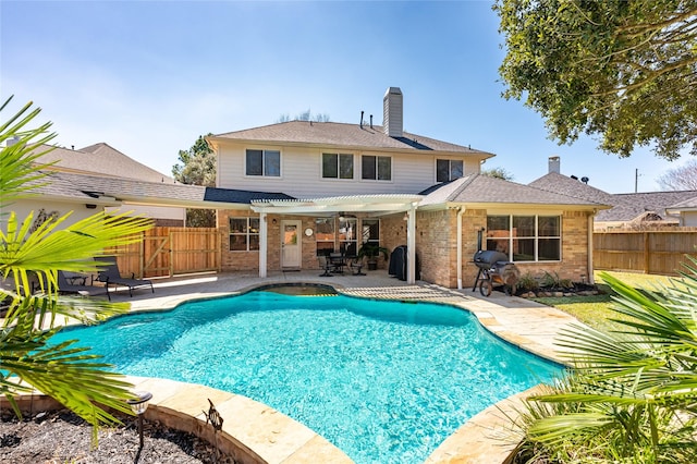 view of pool with a patio area, a fenced in pool, fence, and a pergola