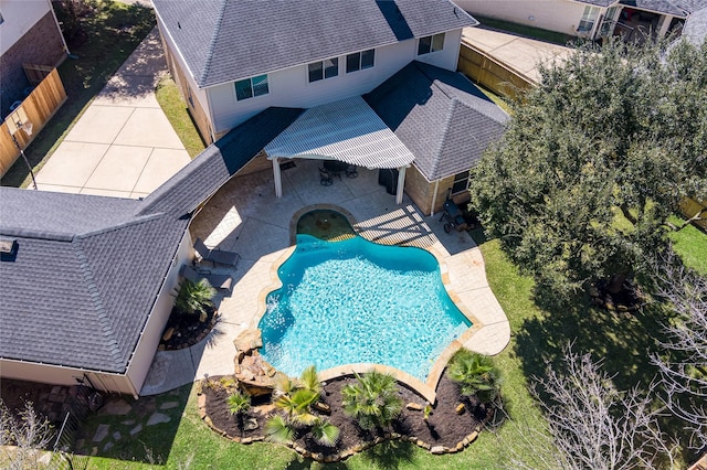 outdoor pool with a patio and a fenced backyard