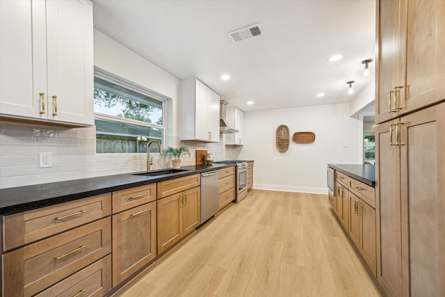 kitchen featuring sink, stainless steel appliances, white cabinetry, and light wood-type flooring