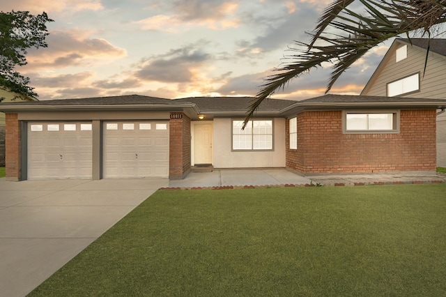 view of front of home featuring a garage and a yard