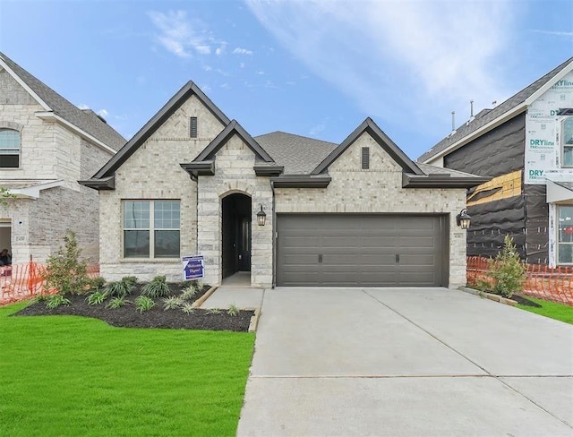 view of front facade with a garage and a front yard