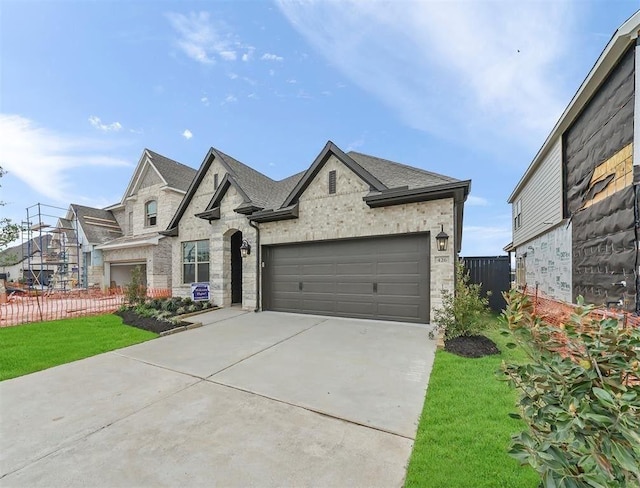 view of front of property featuring a garage and a front yard