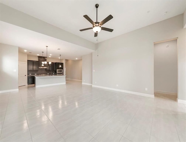 unfurnished living room featuring light tile patterned floors and ceiling fan with notable chandelier