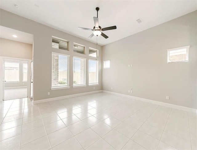 empty room featuring ceiling fan and light tile patterned flooring