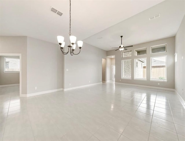 unfurnished room with ceiling fan with notable chandelier and light tile patterned floors