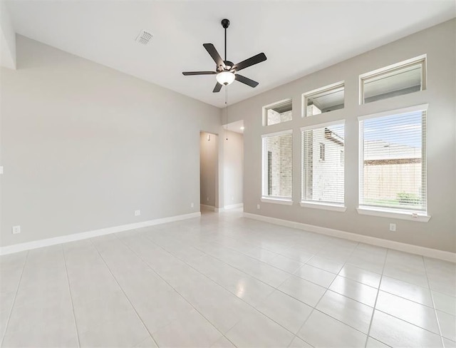 empty room featuring ceiling fan and light tile patterned flooring