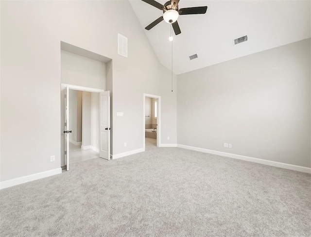 unfurnished bedroom with ceiling fan, light carpet, and high vaulted ceiling