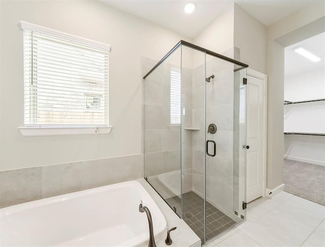 bathroom featuring tile patterned flooring and plus walk in shower