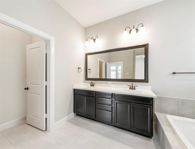 bathroom featuring vanity, tiled bath, and tile patterned floors